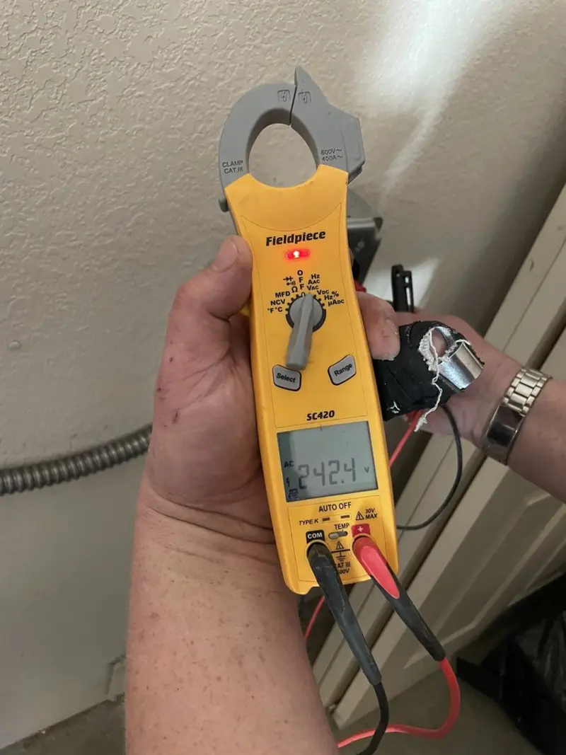 Voltage testing with clamp meter during Outlet Installation in Pantops